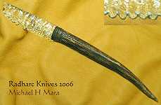 Flintknapped glass blade, serrated edge, with deer antler